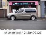 Small photo of 20th February 2024- A stylish Peugeot Partner Tepee Allure, five door MPV, parked on a road in the town center at Carmarthen, Carmarthenshire, Wales, UK.