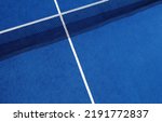Small photo of View of the net and the centre line of a blue paddle tennis court. Racket sports