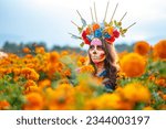 Small photo of Woman with Mexico Catrina makeup in flower field, serious woman in traditional costume and headwear wearing, standing on field among blooming marigold flowers while looking away. Day of death.