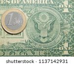 coin 1 euro against a paper... | Shutterstock . vector #1137142931