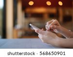 hand of woman and smartphone on ... | Shutterstock . vector #568650901