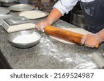 home bakery. Confectioner rolling gingerbread dough with rolling pin.People cooking food