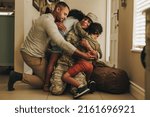 Small photo of Happy military homecoming. Female soldier reuniting with her husband and children after serving in the army. Cheerful servicewoman embracing her family after returning home from deployment.