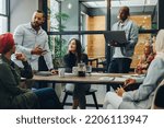 Small photo of Creative business professionals having a group discussion during a meeting in a modern office. Team of multicultural businesspeople sharing ideas in an inclusive workplace.