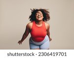 Small photo of Fit having a blast in a dance workout, a lively and expressive physical activity. Woman celebrating her body, flaunting her confidence, and allowing herself to be fully expressed through body movement