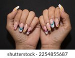 Woman hands with fashionable Colored Gel Nails design. Beauty treatment concept. Fashion Acrylic gel.