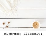 Fashion blog style desk with woman accessory collection: coffee cup, dried flowers, white scarf on cute white background. Flat lay. Top view. Copy space for lettering, text, magazines, headers
