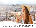 Coffee ads. Beautiful woman take cappuccino with Italian landscape on background. Copy space for advertising.