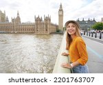 Portrait of smiling tourist woman in London, United Kingdom