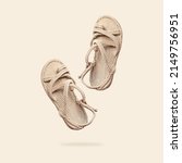 Small photo of Summer female wicker sandals isolated on beige background. Fashionable trendy rope straw sandals. Jute slippers. Handmade Eco-friendly natural shoes. Cut out objects for design, Mock up
