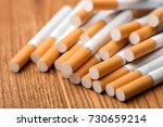 Small photo of cigarette, cigarette on a wooden background, a pack of cigarettes, a close-up of a cigarette