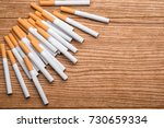 Small photo of cigarette, cigarette on a wooden background, a pack of cigarettes, a close-up of a cigarette