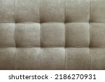 Gray suede leather background for the wall in the room. Interior design, headboards made of furniture fabric, furniture upholstery. Classic checkered pattern for furniture, wall, headboard