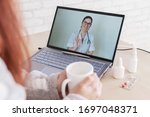 Small photo of A woman is on sick leave. The patient consults a doctor online. Video chat with the doctor on the laptop. The therapist gives tips for treating the disease.
