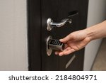 Woman opens the combination lock on the door to the apartment. Keyless entry. 