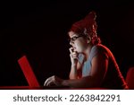 Small photo of Paranoid caucasian woman typing on a computer wearing a tinfoil cap. Conspiracy theory.