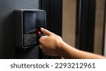 Small photo of A woman opens the door with her fingerprint. Modern keyless entry lock.