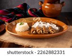 Small photo of Chicken enmoladas. Also known as mole poblano enchiladas, they are a typical Mexican dish that is very popular in Mexico and the rest of the world.
