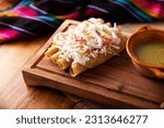Small photo of Tacos Dorados. Mexican dish also known as Flautas, consists of a rolled corn tortilla with some filling, commonly chicken or beef or vegetarian options such as potatoes.
