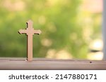 Small photo of Wooden Christ cross background. Christcross and garlic are believed that can protect from ghost and bad spirit. Christianity belief with peaceful belong to Jesus.