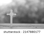 Small photo of Wooden Christ cross background. Christcross and garlic are believed that can protect from ghost and bad spirit. Christianity belief with peaceful belong to Jesus.