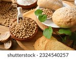 Small photo of Bread made with soy flour on rustic wooden table with bread, flour and soy beans in the countryside. Elevated view.