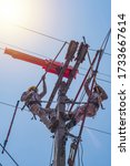 Small photo of Two linesmen use insulated equipment to repair and maintain high-voltage distribution systems. The operation is done without power outage. Is a risky job, the operator must be trained.