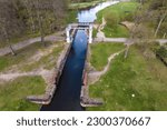 Small photo of aerial view over dam lock sluice on lake impetuous waterfall