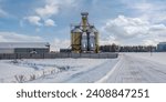 Small photo of modern agro-processing plant for processing and silos for drying cleaning and storage of agricultural products, flour, cereals and grain in snow of winter field