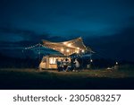 Asian LGBTQ+ couple drinking and barbecue in a romantic camping setting. Groups of friends and couples having a drink party in a camping atmosphere amidst forests and rivers.