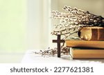 Small photo of wooden cross, old biblical books and willow twigs close up on table, abstract light background. Orthodox palm Sunday, Easter holiday. Symbol of Christianity, Lent, Faith in God, Church. copy space