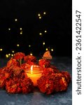 Small photo of burning candle, butterflies and marigold flowers on abstract dark background. cempasuchil flowers - symbol of Mexico's Day of the Dead. dia de los Muertos holiday concept. esoteric spiritual ritual