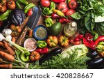 Fresh raw vegetable ingredients for healthy cooking or salad making, top view. Olive oil in bottle, spices and knife. Diet or vegetarian food concept