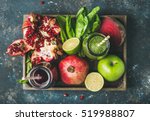 Green and purple fresh juices or smoothies with fruit, greens, vegetables in wooden tray, top view, selective focus. Detox, dieting, clean eating, vegetarian, vegan, fitness, healthy lifestyle concept