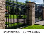 
A modern metal fence around the house