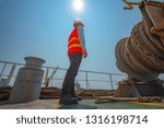 Small photo of ship crew under safe working in communicating for mooring wince on board the ship, arrival and departure or berthing, un-berthing of the ship perform by the crew member working in charge