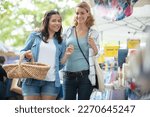 women on vacation walking in outdoor market