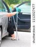 Small photo of Disabled woman upgoing from a car. Transportation and travel for handicapped people. a11y