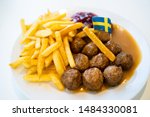Swedish traditional meatballs with fried potatoes and cranberry sauce. Swedish food concept.