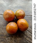 Small photo of nealy rotten oranges on wood background