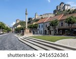 Small photo of TRENCIN, SLOVAKIA - MAY 22, 2020: Plague Pillar (Morovy stlp) in the city center. Plague monument placed on main square. Trencin Castle in the background. Trencin, Western Slovakia, Central