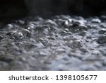 Small photo of A selective focus of surface of boiling water allowing small bubbles of vapour form at discrete points.