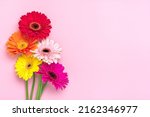 Bouquet of gerberas on pink background Top view Flat lay Holiday greeting card Happy moter's day, 8 March, Valentine's day, Easter concept Copy space Mock up.