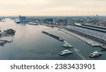 Small photo of Amsterdam, Netherlands - July 22, 2023: A barge loaded with coal passes near Amsterdam Central Station. Bay IJ (Amsterdam), Aerial View