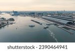 Small photo of Amsterdam, Netherlands - July 22, 2023: A barge loaded with coal passes near Amsterdam Central Station. Bay IJ (Amsterdam), Aerial View