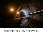 Small photo of Underground vaulted urban sewer tunnel with dirty sewage.