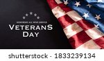 Happy Veterans Day concept. Vintage American flags against blackboard  background. November 11.