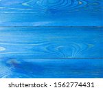 Small photo of Wooden Board painted by blue paint. The texture of the wood, where you want to copy. Template subtext