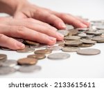 Small photo of Close-up of male hands lying on coins of Russian rubles. The concept of wealth and affluence. Economy, money, business. Side view