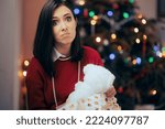 Small photo of Woman Unhappy with her Lousy Christmas Gift Discontent girlfriend receiving an underwhelming present